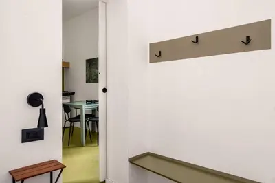 a hallway with a door leading into a room with a table at Azizò, la Verde in Palermo