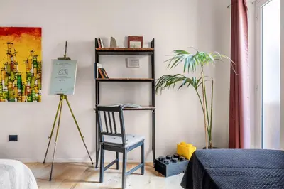 a bedroom with a chair and a plant in a room at Azizò, la Verde in Palermo
