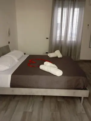 a bed with two towels on top of it at Marisol in Palermo
