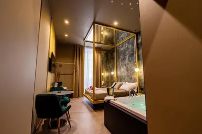 a bathroom with a tub and a bedroom with a bed at GOLD Suite&SPA in Palermo