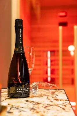 a bottle of wine sitting on a table with a glass at GOLD Suite&SPA in Palermo