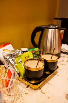 two bowls of soup on a tray with a tea kettle at GOLD Suite&SPA in Palermo