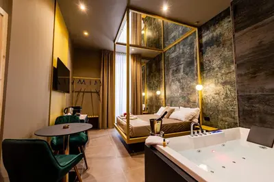 a hotel room with a tub and a bed at GOLD Suite&SPA in Palermo