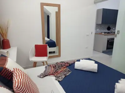 a living room with a bed and a mirror at Casa Grazia in Partinico