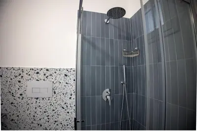 a shower with a glass door in a bathroom at Casa Grazia in Partinico