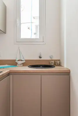 a kitchen counter with a sink and a window at Casetta al Molo di Mondello by Wonderful Italy in Palermo