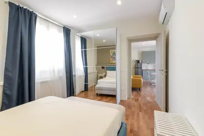 a bedroom with a bed and a mirror at GuestHost - Palermo's Rooftop - Apt with Panoramic Terrace in Palermo