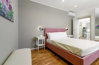 a bedroom with a large bed with a pink headboard at GuestHost - Palermo's Rooftop - Apt with Panoramic Terrace in Palermo