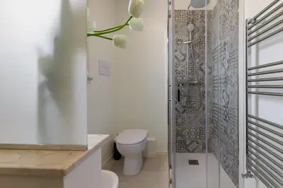 a bathroom with a toilet and a shower at GuestHost - Palermo's Rooftop - Apt with Panoramic Terrace in Palermo