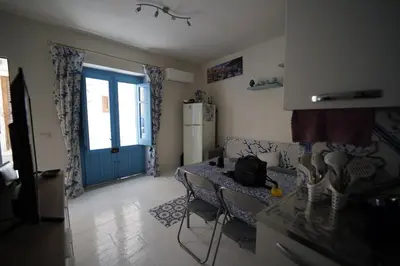 a living room with a couch and a table and a door at Casa di via Sole in Castellammare del Golfo