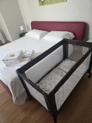 a bed with a black frame and white sheets at Da Lila a Ballarò in Palermo