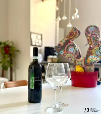 a bottle of wine sitting next to a wine glass at Da Lila a Ballarò in Palermo