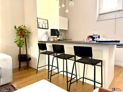 a kitchen with a bar with three stools at Da Lila a Ballarò in Palermo