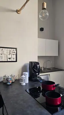 a kitchen counter with pots and pans on a stove at Da Lila a Ballarò in Palermo