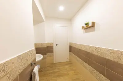 a bathroom with a white toilet and a sink at I RE di SICILIA 2 in Palermo