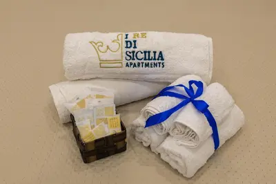 a pile of towels and a box of towels at I RE di SICILIA 2 in Palermo