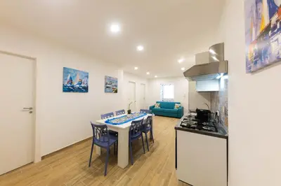 a kitchen and living room with a table and a stove at I RE di SICILIA 2 in Palermo