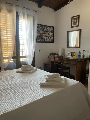a bedroom with a white bed with towels on it at Le Terrazze Élite Apartment in Palermo