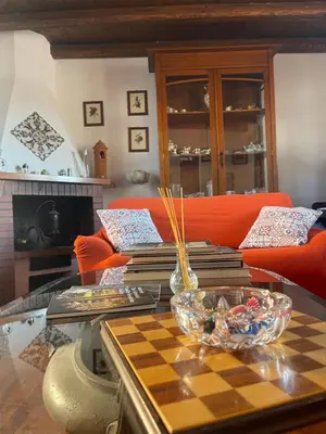 a living room with a table with books on it at Le Terrazze Élite Apartment in Palermo