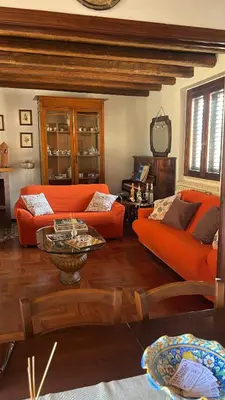 a living room with an orange couch and a table at Le Terrazze Élite Apartment in Palermo
