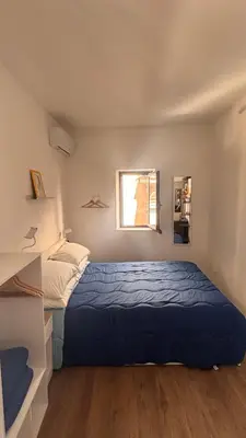 a small bedroom with a bed and a window at caZA' Capo 40MQ nel centro di Palermo in Palermo