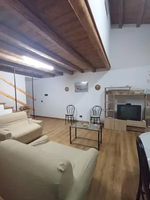 a living room with a couch and a tv at B&b da Ely in Ventimiglia di Sicilia