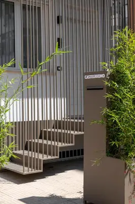 a gate in front of a building with benches at Cilea Apartments in Palermo