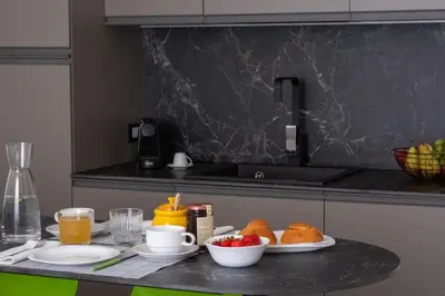 a table with two plates of food on a counter at Cilea Apartments in Palermo