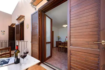 a door leading to a dining room with a table and wine glasses at I Tre Golfi - Pianeti in San Vito lo Capo