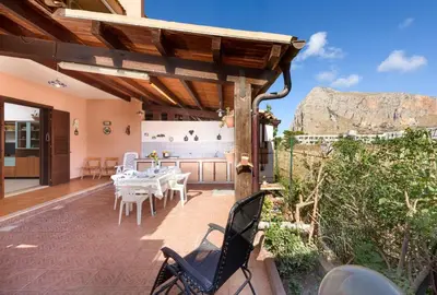 a patio with a table and chairs on a deck at I Tre Golfi - Pianeti in San Vito lo Capo