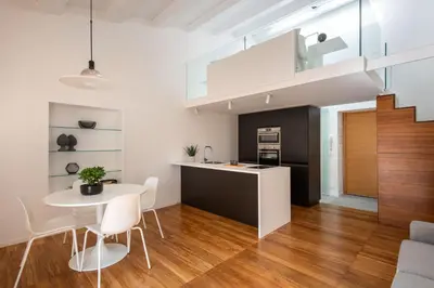 a kitchen and living room with a table and chairs at Kalsa miniLoft by Wonderful Italy in Palermo