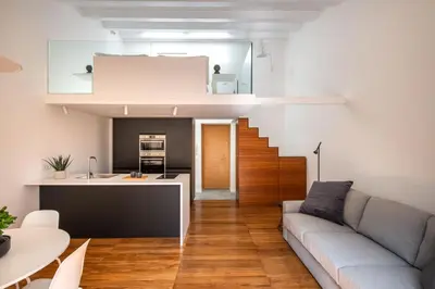 a living room with a couch and a kitchen at Kalsa miniLoft by Wonderful Italy in Palermo
