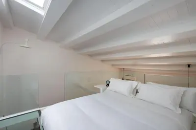 a bedroom with a white bed and a window at Kalsa miniLoft by Wonderful Italy in Palermo