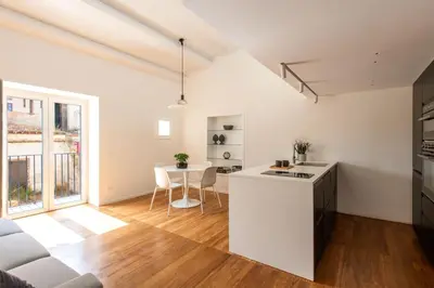 a kitchen and living room with a white counter top at Kalsa miniLoft by Wonderful Italy in Palermo