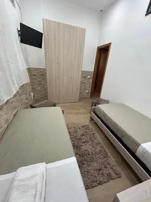 a bedroom with two twin beds and a rug at Home Love in Palermo