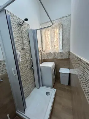 a small bathroom with a shower and a toilet at Home Love in Palermo