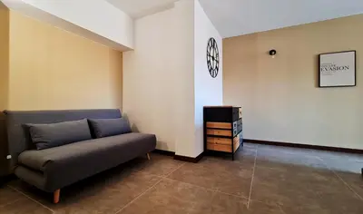 a living room with a couch and a tv at The blue and red rooms in Bagheria