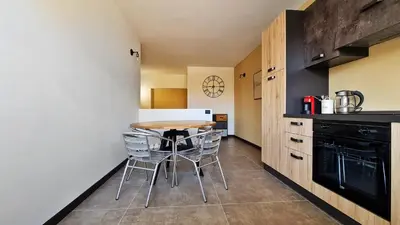 a kitchen with a table and chairs in a room at The blue and red rooms in Bagheria