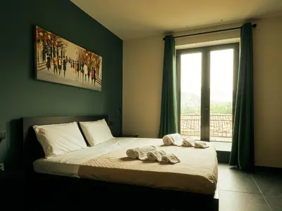 a bedroom with a bed with two towels on it at HUB Rooms in Carini