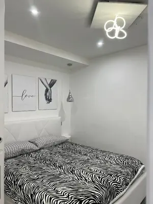 a white room with a zebra print bed in it at Pietro Fudduni Apartment in Palermo