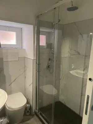 a bathroom with a shower and a toilet and a sink at Pietro Fudduni Apartment in Palermo