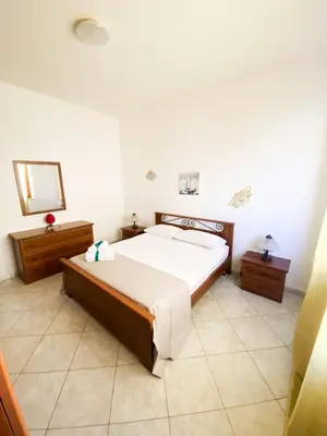 a bedroom with a large bed and a mirror at Sole di Sicilia in Castelluzzo