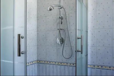 a shower in a bathroom with a glass door at Casa Maria Grazia Villa indipendente con vista mozzafiato a Monreale in Monreale