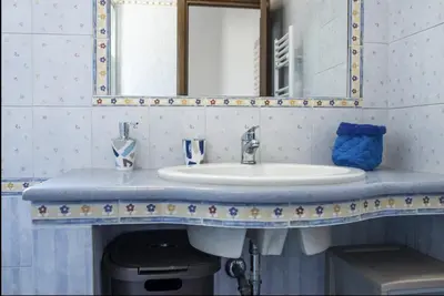 a bathroom with a sink and a mirror at Casa Maria Grazia Villa indipendente con vista mozzafiato a Monreale in Monreale