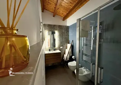 a bathroom with a toilet and a sink and a shower at Mansarda Florio in Palermo