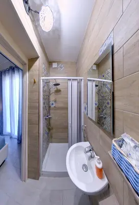 a bathroom with a shower and a white sink at Isola dei tesori - affittacamere palermo in Palermo