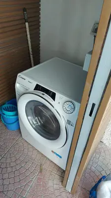 a washing machine is sitting in a room at Mondello House in Palermo