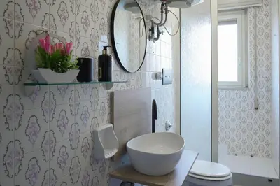 a bathroom with a toilet and a sink and a mirror at Dolce Sicily a 2km dal centro in Palermo
