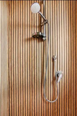 a bathroom with a shower on a wooden wall at Dolce Sicily a 2km dal centro in Palermo