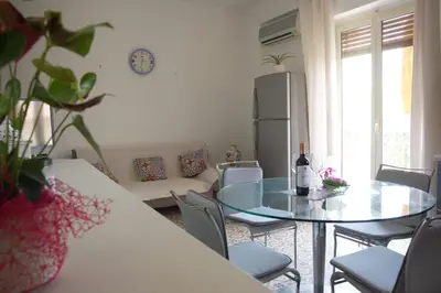a living room with a glass table and chairs at Dolce Sicily a 2km dal centro in Palermo